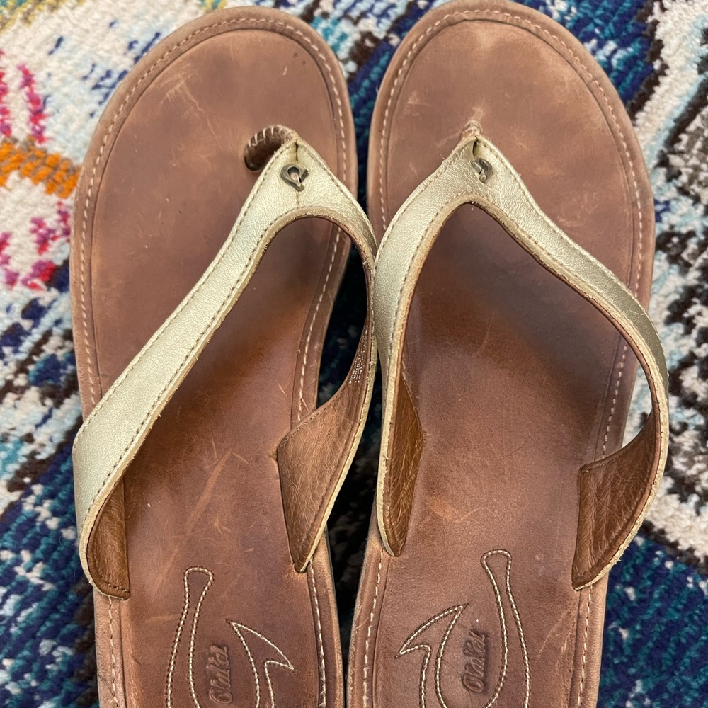 Olukai gold wedge flip flops
